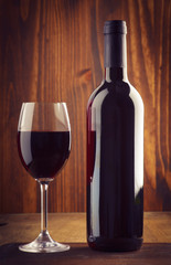 glasses and bottle of wine on old wood