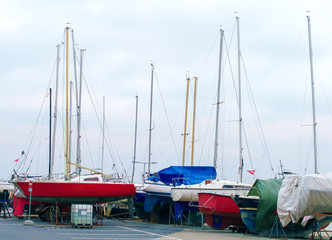 Fototapeta na wymiar Yachts parked on the beach in the off-season.