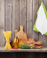 Kitchen utensils, herbs and spices on shelf