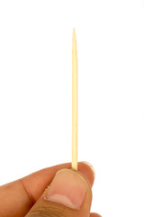 Hand holding one toothpick