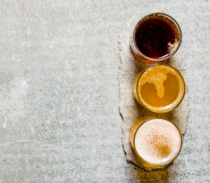 Three Beers On Stone Pedestal. Free Space For Text.