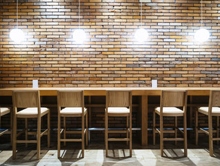 Table counter Bar with Chairs and Lights Brick wall background Loft style Interior