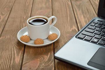 Obraz na płótnie Canvas Cup of coffee and laptop