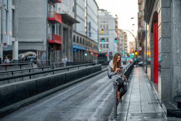 Fototapeta na wymiar Woman with phone in the city