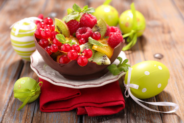 fruit salad in chocolate bowl with easter decoration