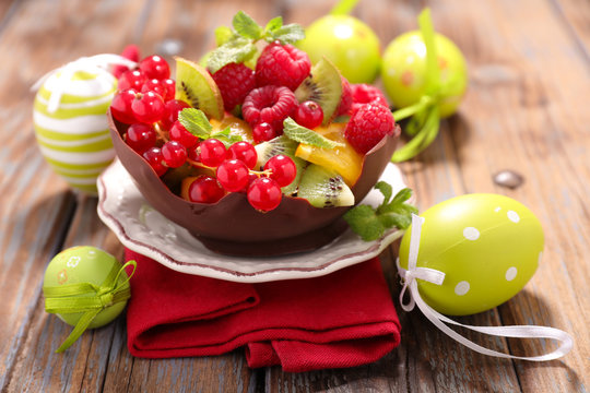 fruit salad in chocolate bowl with easter decoration