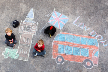 Two kid boys in british soldier policeman uniform with London pi