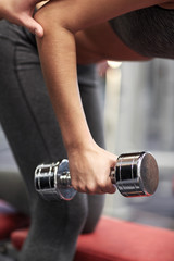 close up of couple with dumbbell exercising in gym