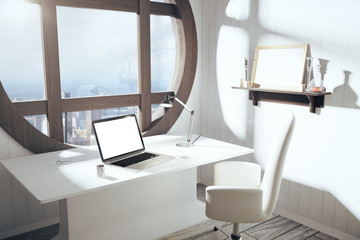 Blank white laptop screen on white table with chair and round wi