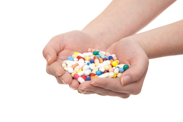 Hands full of pharmaceuticals. All on white background.