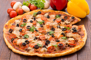 Pizza with Mozzarella, Sauce, Tomatoes and Salad Leaves