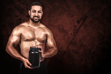 Composite image of muscular man with protein powder