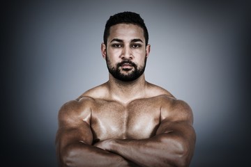 Composite image of muscular man flexing for camera