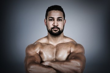 Obraz premium Composite image of muscular man flexing for camera