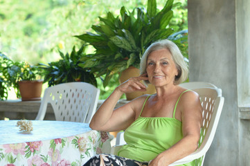 Fototapeta premium Older woman resting at tropical resort