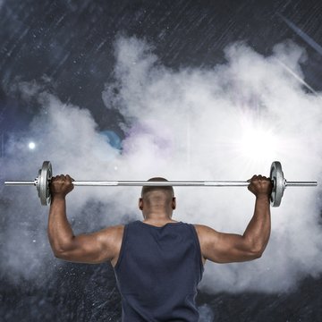 Composite image of fit man lifting heavy barbell