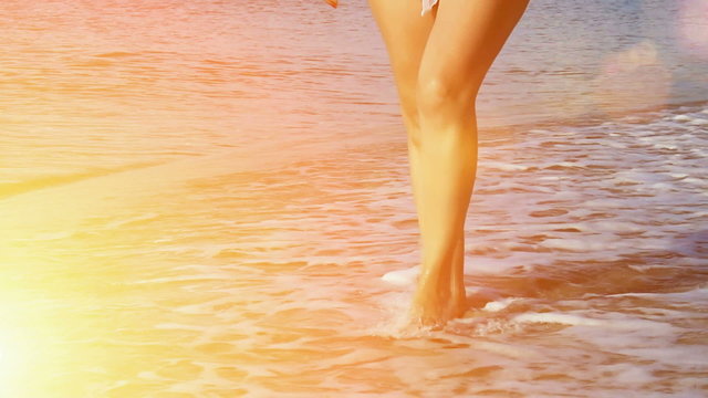 A young woman with bare feet walking on the sea beach in slow motion, Slow Motion Video clip