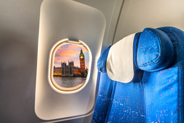Airplane window with view on Westminster. Tourism concept