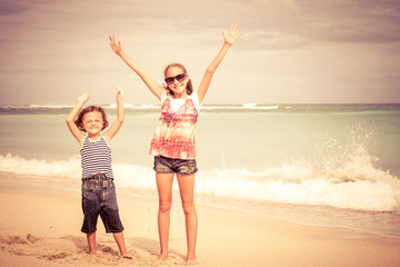 Sister and brother playing on the beach at the day time.