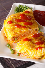 Japanese omelet with rice Omurice close-up on a plate. Vertical
