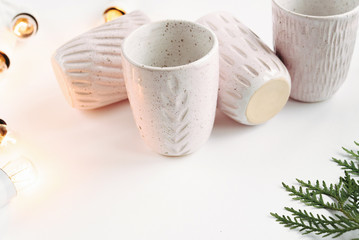 stylish creative ceramics cups and christmas garland lights, hol