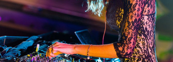 DJ turntable console mixer controlling with two hands