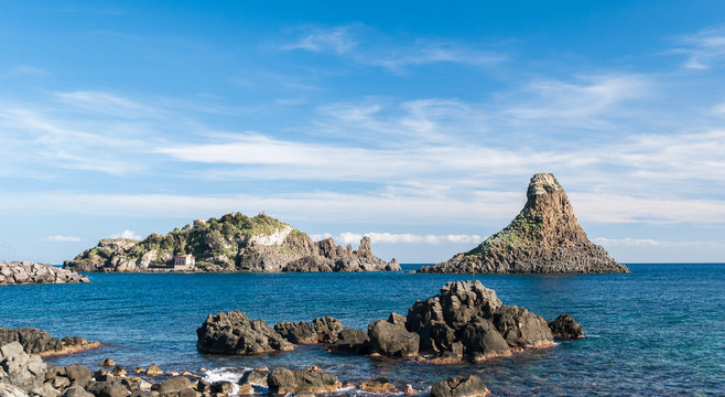 Island Lachea and a sea stack, geological features in Acitrezza (Sicily)