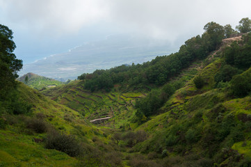 Fototapeta na wymiar Steep green valley viewpoint leading to blue ocean coast of cape verde island