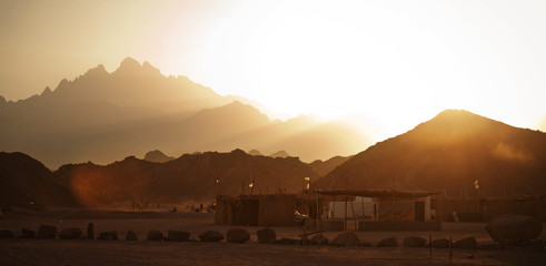 Beduin village in desert in mountains in sunset