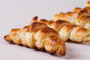 Croissant with a crispy crust on a white surface
