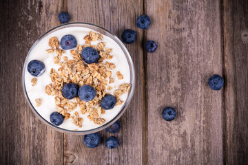 Yogurt with granola and blueberries.