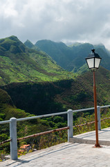 Fototapeta na wymiar Lantern in front of barrier and green valley or mountain cape verde