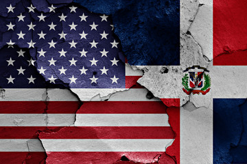 flags of USA and Dominican Republic painted on cracked wall