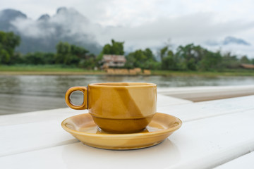 Coffee cup ceramic with Song river (Vang Vieng Laos) and cloud b