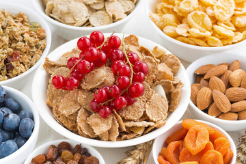 assortment of different breakfast cereal, dried fruit 