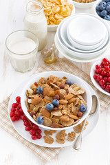 breakfast with cereals flakes and berries, vertical top view