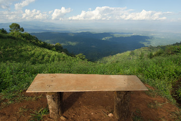 Lonely chair with grass, mountain and cloudy sky view of Chiangm