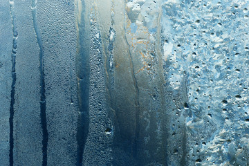 frozen water drops on glass with streaks