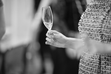 Wine glass in female hand;monochrome