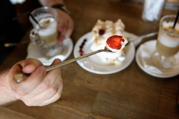 the groom holds the spoon meringue