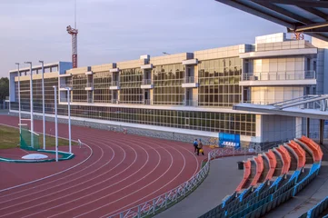 Fotobehang Stadion Atletiekstadion. Loopbanden. Geglazuurde muur van het gebouw.