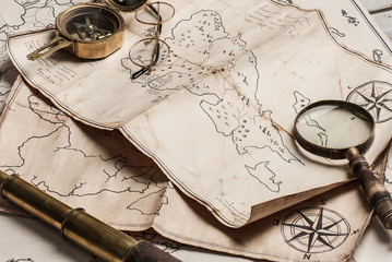 An old brass compass on map background