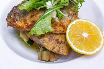 Cooked dorado fish with vegetables, closeup