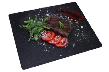 Grilled veal steak with vegetables, closeup