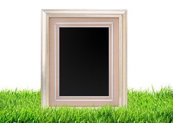 Photo frame on green grass nature background
