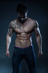 Naklejka na ściany i meble male fitness model with the tattoo