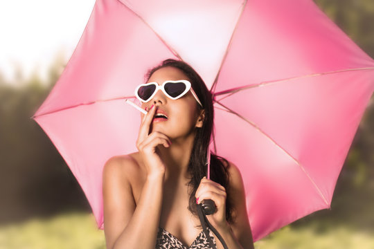 Beautiful Mexican woman smoking with umbrella