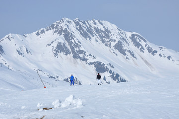 Fototapeta na wymiar Skiers skiing in the Alps