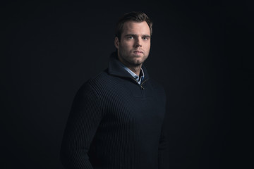 Obraz premium Fashionable man wearing dark blue winter sweater with light blue