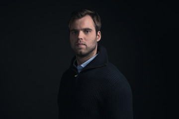 Obraz premium Fashionable man wearing dark blue winter sweater with light blue